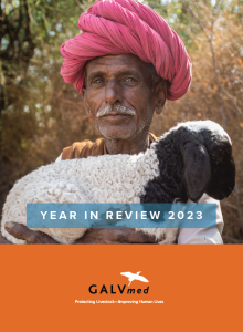 Man holding a goat. This is the cover of the Year in Review 2023.